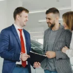 Person leasing a new car at a dealership in Canada and the UK