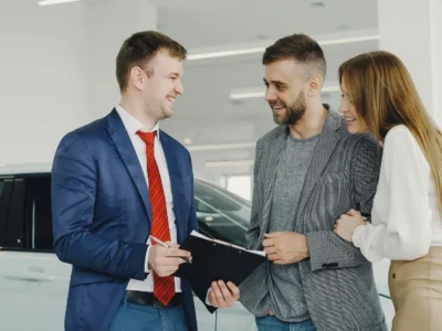 Person leasing a new car at a dealership in Canada and the UK
