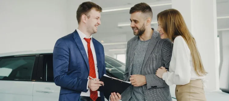 Person leasing a new car at a dealership in Canada and the UK